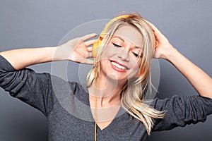 Girl dancing in listening to music on headphones to relax