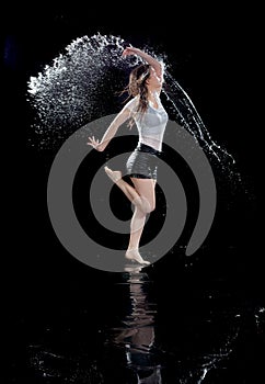 Girl dancing rain black background