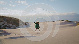 Girl dancing sand dunes at summer evening. Woman performing sensually movements.