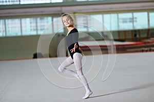 Girl dancing on training rhythmic gymnastics