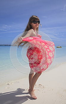 Girl dancing on the white sandy beach