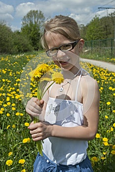 Girl and dandelion flowers