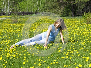 Girl on dandelion lawn