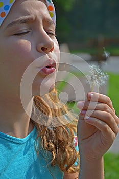 Girl and dandelion wish