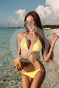 girl with dark hair in elegant beach clothes, relaxing on M