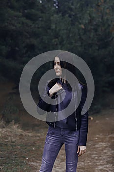 Girl with dark hair in the forest.