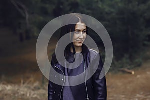 Girl with dark hair in the forest.