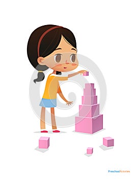 Girl with dark hair stands and builds tall pyramid using pink cubes. Child plays with bright colored blocks
