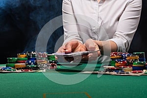 Girl dealer, croupier hands out poker cards in a casino, concept for business games, casino