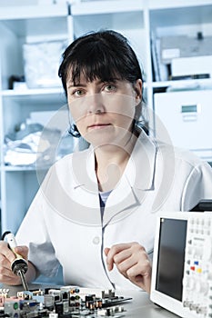 Girl debugging an electronic precision device photo