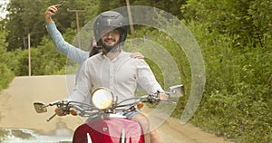 The girl decided to take a selfie while riding a scooter with her lover