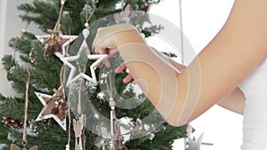 Girl decorates the Christmas tree
