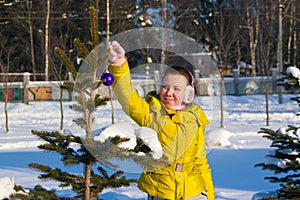 Girl decorating christmas tree