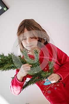 Girl decorating a Christmas tree