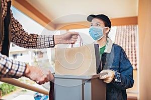 Girl is delivering some groceries to an elderly person. Contactless delivery during the quarantine