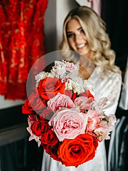 Girl demonstrates a bouquet of red roses, selective focus.