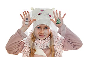 Girl demonstrating Christmas symbols painted on her hands. Snowman and Christmas tree