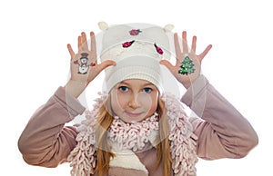 Girl demonstrating Christmas symbols painted on her hands. Snowman and Christmas tree