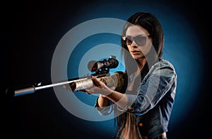 A girl in a denim jacket with a sniper rifle