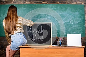 Girl denim skirt breaking school clothing rules. Student teacher mini skirt sexy buttocks sit table blackboard