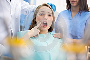 Girl in dental ambulance show sore spot