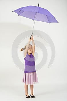 A girl with departing from the wind purple umbrella photo