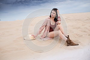 Girl in desert sit, dream and smile, sand and blu sky