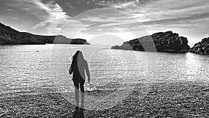 Girl on deserted beach near ancient Greek city Knidos, Turkey, bw