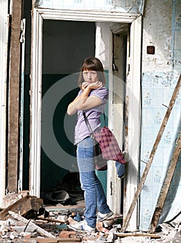 Girl in a destroyed building