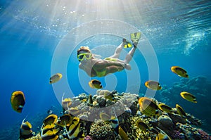 Girl dives in a tropical sea photo