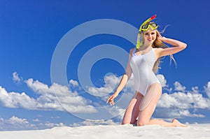 Girl with diving mask on the beach