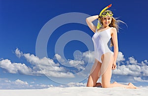 Girl with diving mask on the beach