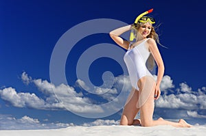 Girl with diving mask on the beach