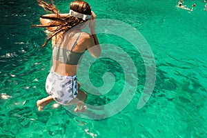 Girl diving in the sea enjoying summer vacations in Zakynthos island in Greece.