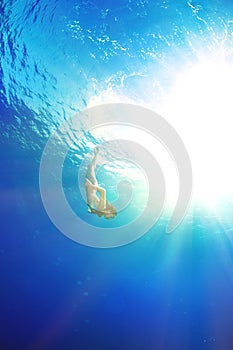 Girl diving under the sea