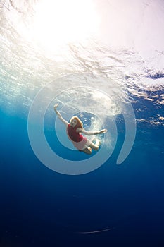 Girl diving under the sea