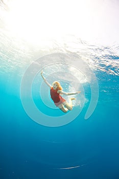 Girl diving under the sea