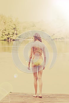 Girl on a dock ready to swim