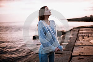 Girl in a sweater near the sea