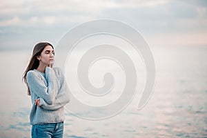 Girl in a sweater near the sea