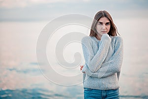 Girl in a sweater near the sea