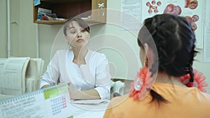 A girl at a doctor`s reception. A female doctor holds a conversation with a patient.