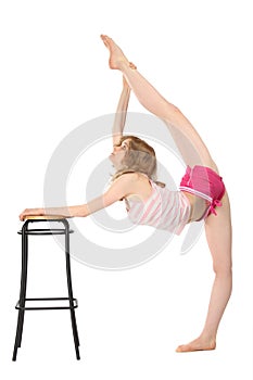 Girl does gymnastics, keeping for stool