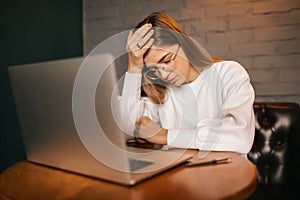 The girl does hard work at the computer, complex tasks