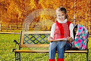 Girl does homework in the park