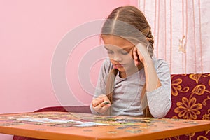 Girl does not know where to put the next puzzle element