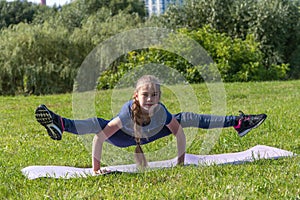 girl does side split exercise