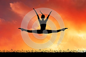 Girl does the splits at sunset