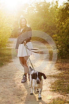 Girl and dog in autumn park