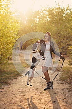 Girl and dog in autumn park